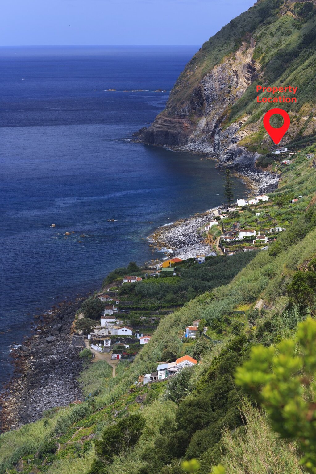 Aerial view of the Rocha da Relva coastline, the cliffside village, and the property marked on the hillside