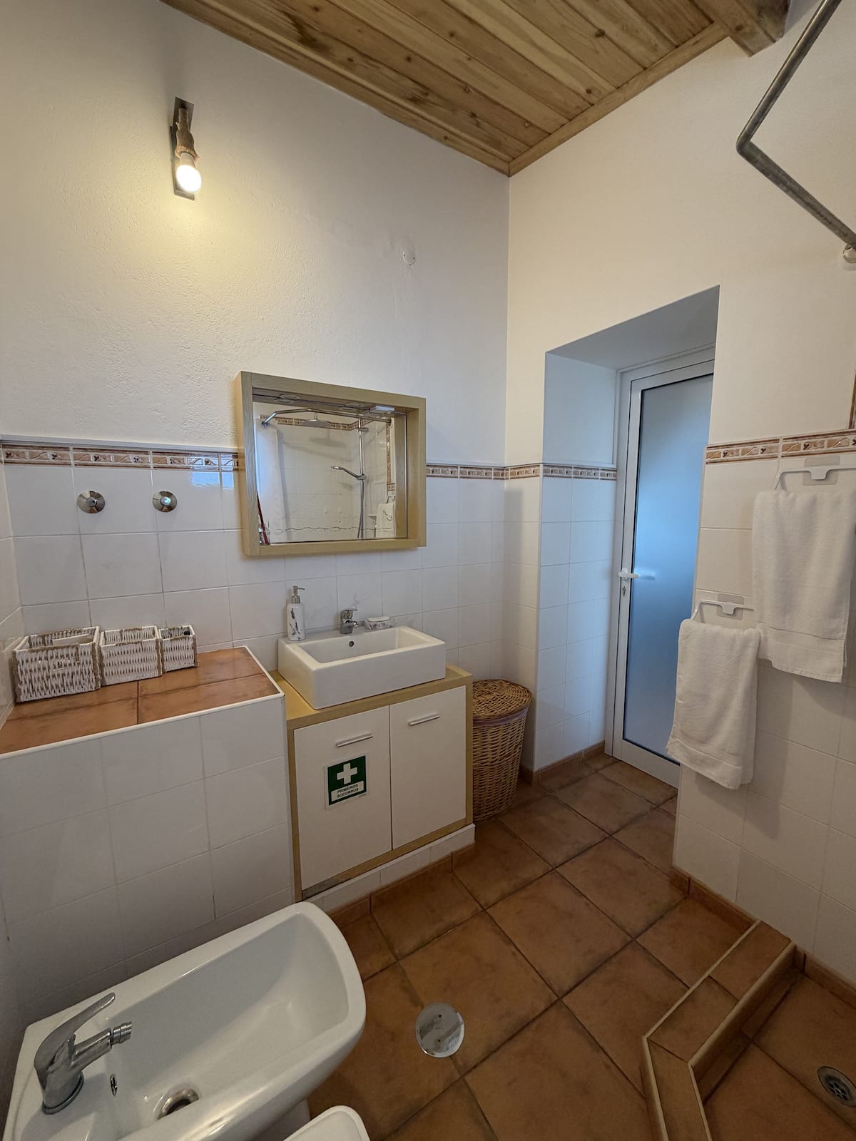 Tiled bathroom with sink and walk-in shower